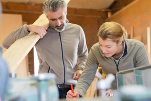 woodworker looking at the design to make