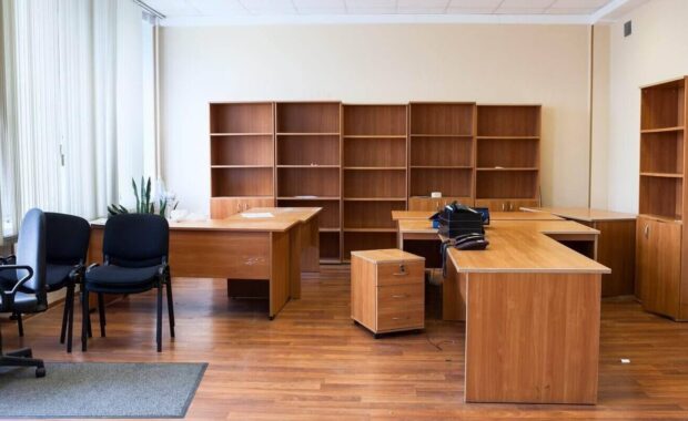 remaining furniture as tables, chairs and cabinets in empty office after the tenant's eviction