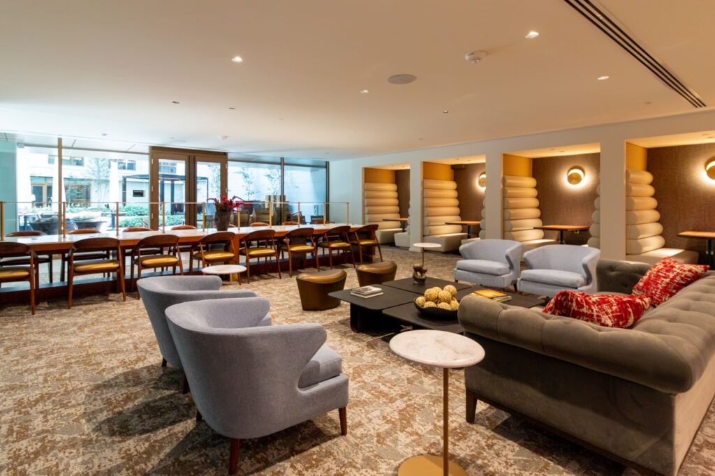 This perspective shifts the focus toward the social lounge area at 1425 NY Ave, highlighting the diverse textures and seating arrangements that encourage collaboration and relaxation.