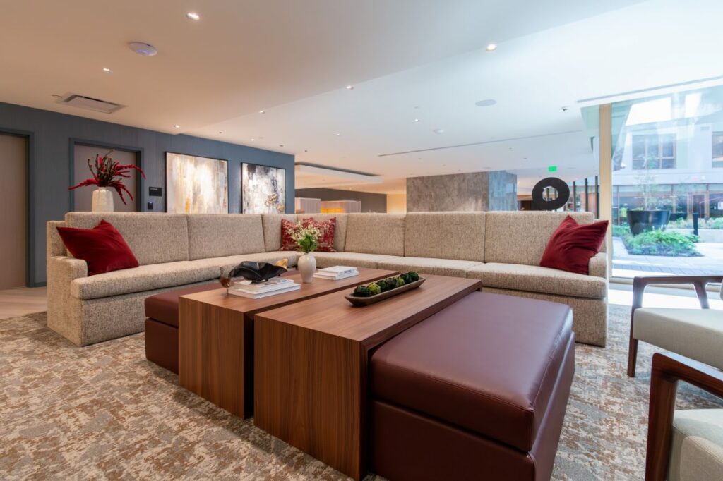 This final wide shot of the 1425 NY Ave lounge provides a full view of the modular furniture system, emphasizing how the "nested" coffee table and ottoman set functions as the anchor of the seating area.