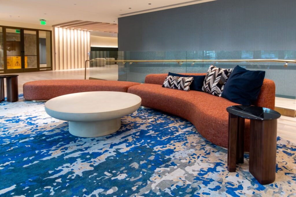 This final lounge area at 1425 NY Ave emphasizes organic shapes and high-contrast textures, creating a sculptural focal point within the office's circulation space.