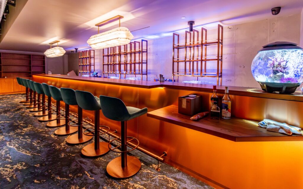 Long bar with custom millwork and bar stools at Florer&iacute;a, Washington, DC.