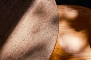 close-up detail of rich wood texture and grain patterns on a round table edge