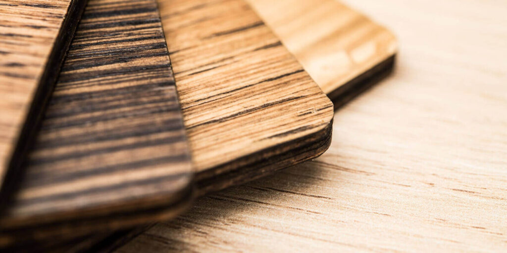 varnished wood samples arranged on a light wooden surface - custom retail millwork