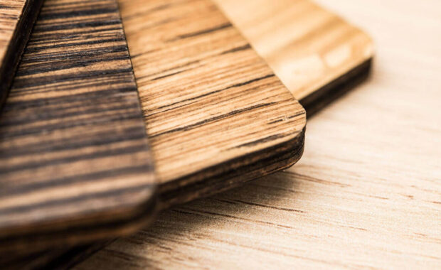 varnished wood samples arranged on a light wooden surface - custom retail millwork