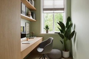 modern small home office nook with green walls and built in wooden desk