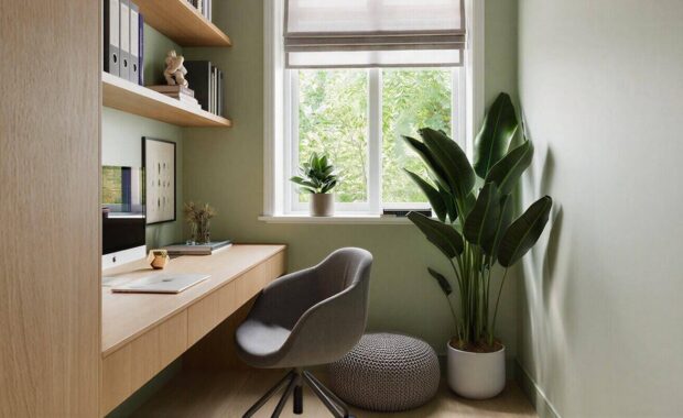 modern small home office nook with green walls and built in wooden desk