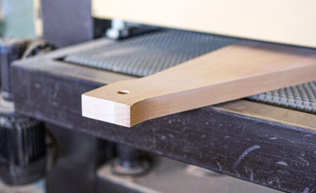precision woodworking machinery sanding timber component in workshop
