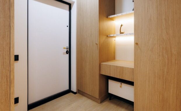stylish urban residence showcases cozy wooden entryway with lluminated shelf and seating area